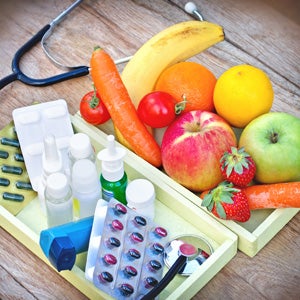 Probiotics - medicines with fruit alongside.