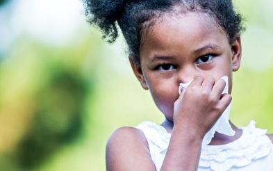 A girl blowing her nose